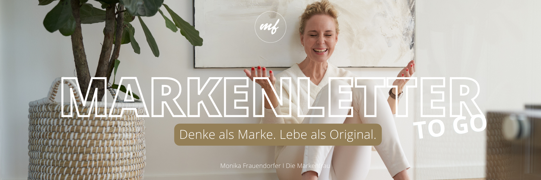 Markenletter-go-go von Monika Frauendorfer. Sie sitzt vor einem Bild am Boden und schaut schelmisch.